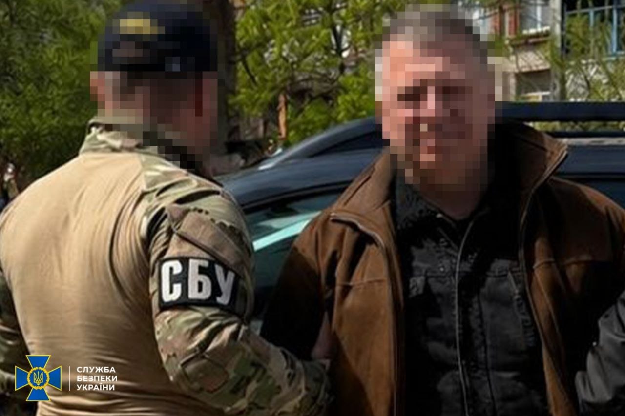 Затриманий стоїть з правоохоронцем